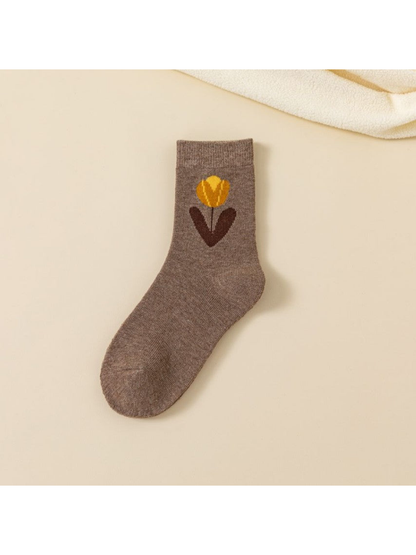 Brown crew sock with a large yellow flower and dark leaves