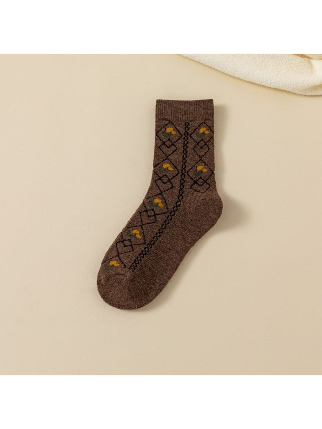 Dark brown crew sock with black diamond lattice and yellow floral accents