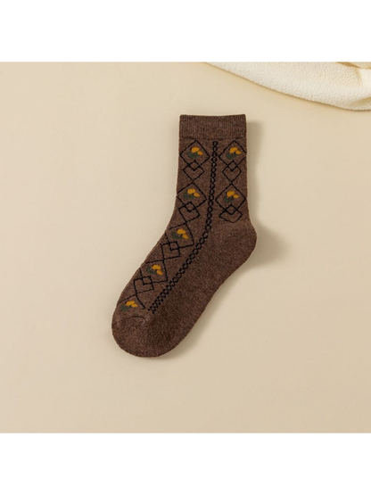 Dark brown crew sock with black diamond lattice and yellow floral accents