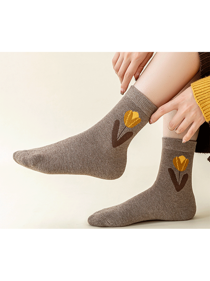 Brown flower crew socks worn while seated