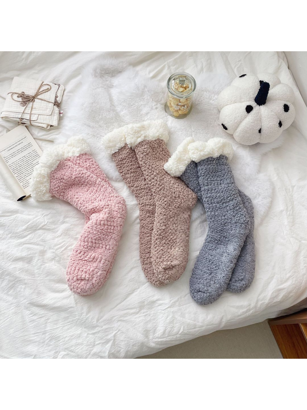 Gray, light pink and greige fuzzy crew socks with ivory cuffs displayed together