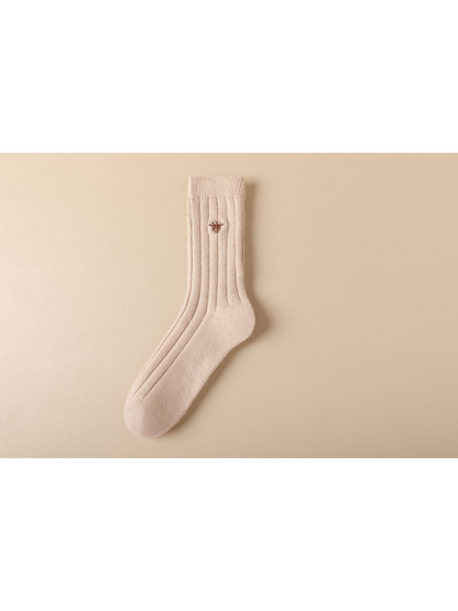 Light beige ribbed crew sock with brown embroidered insect motif