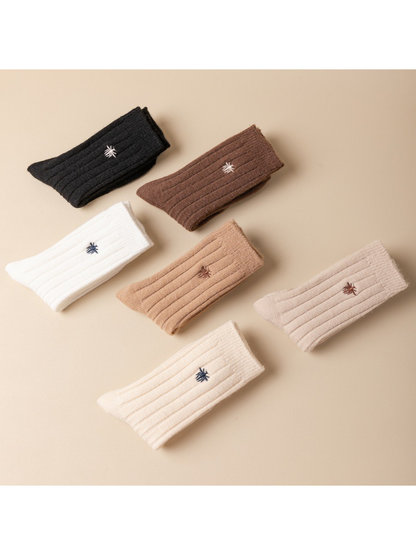 Six neutral-color ribbed socks arranged in a flat display