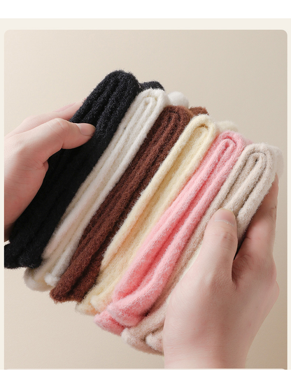 Close-up of folded fuzzy socks in six colors