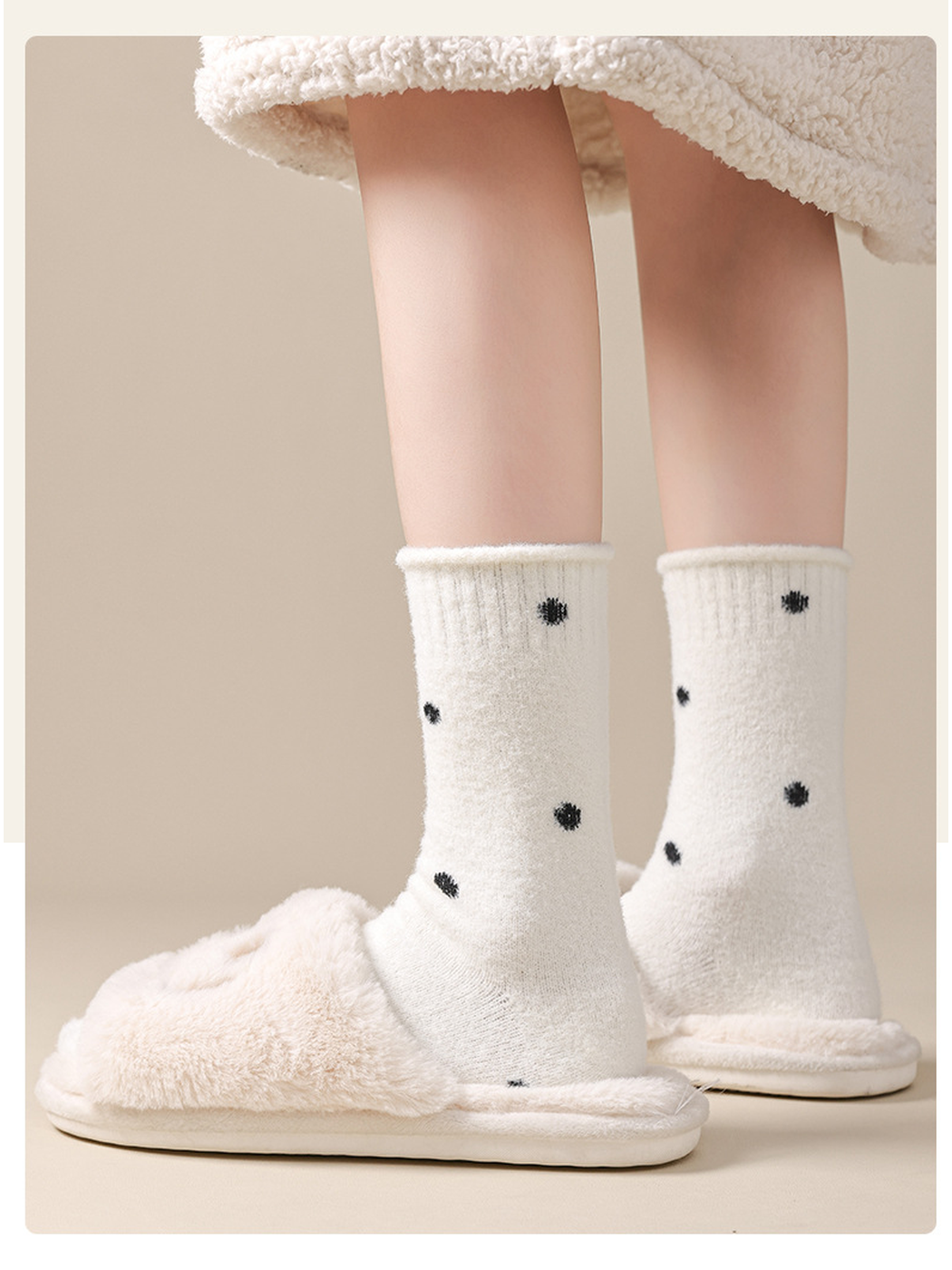 White polka-dot crew socks styled with plush slippers