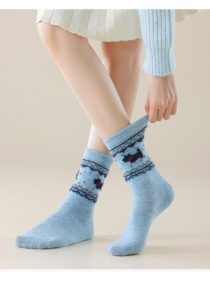 Light blue dog-motif crew socks worn with cuffs pulled up