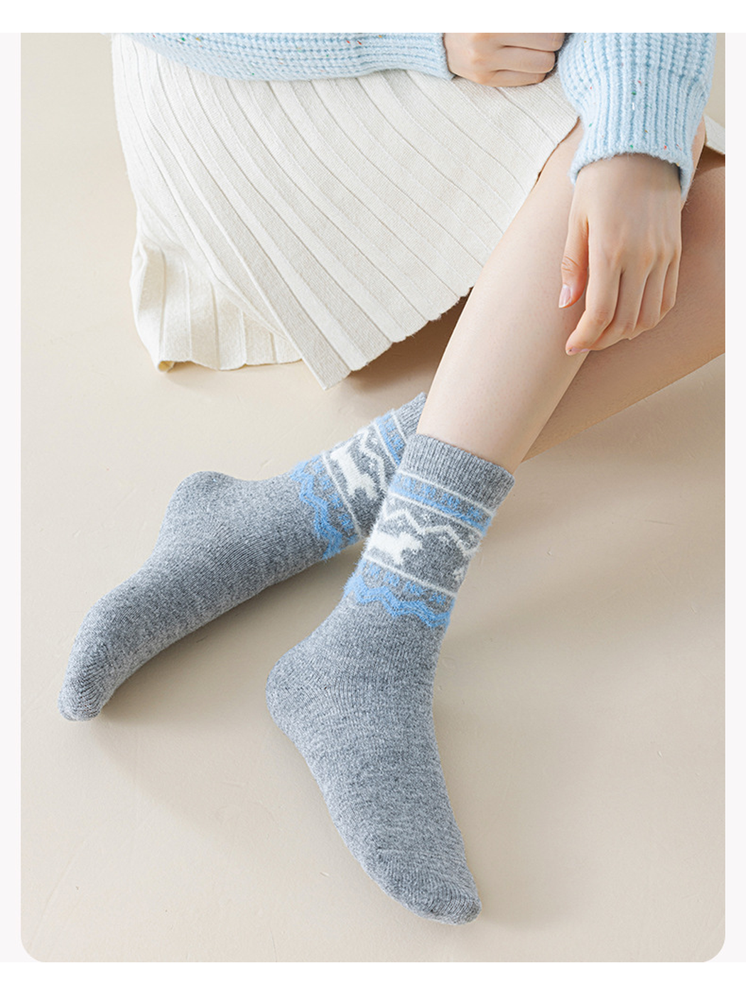 Dark gray dog-motif crew socks worn while seated