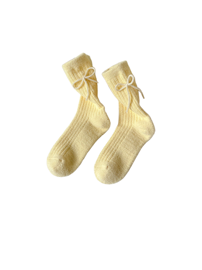 Pale yellow ribbed bow-accent crew socks displayed as a pair