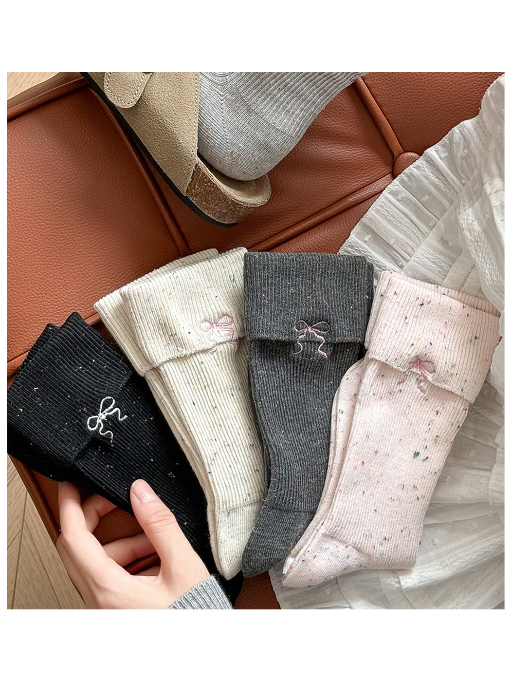 Four speckled crew sock colors arranged in a styled setting