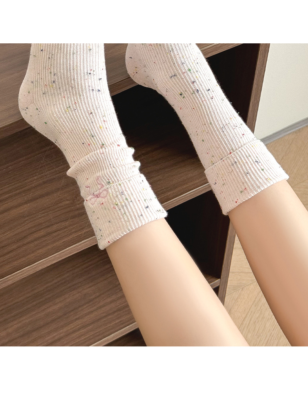Light pink speckled crew socks worn with folded cuffs