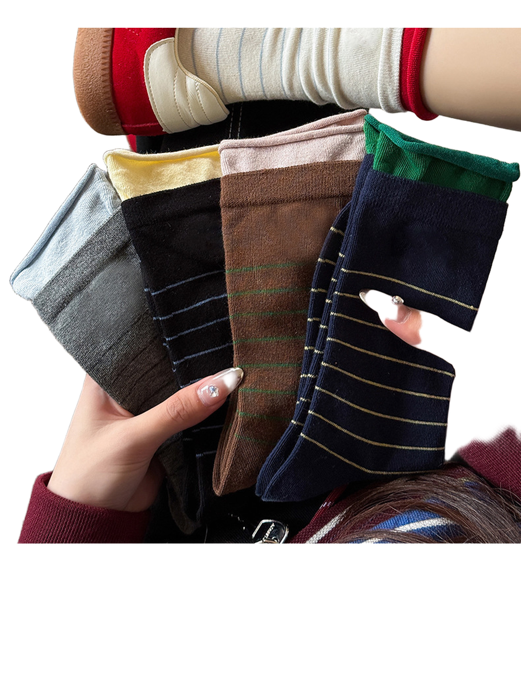 Gray, black, brown and navy striped crew socks held together beneath an ivory worn pair