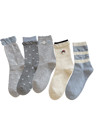 Five gray, ivory and blue crew sock styles displayed together