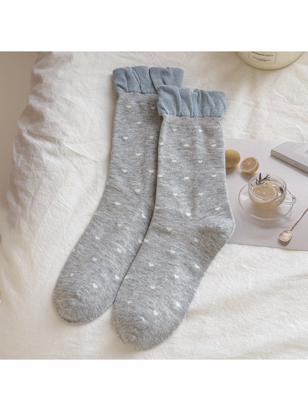 Light gray crew socks with white hearts and gathered blue cuffs