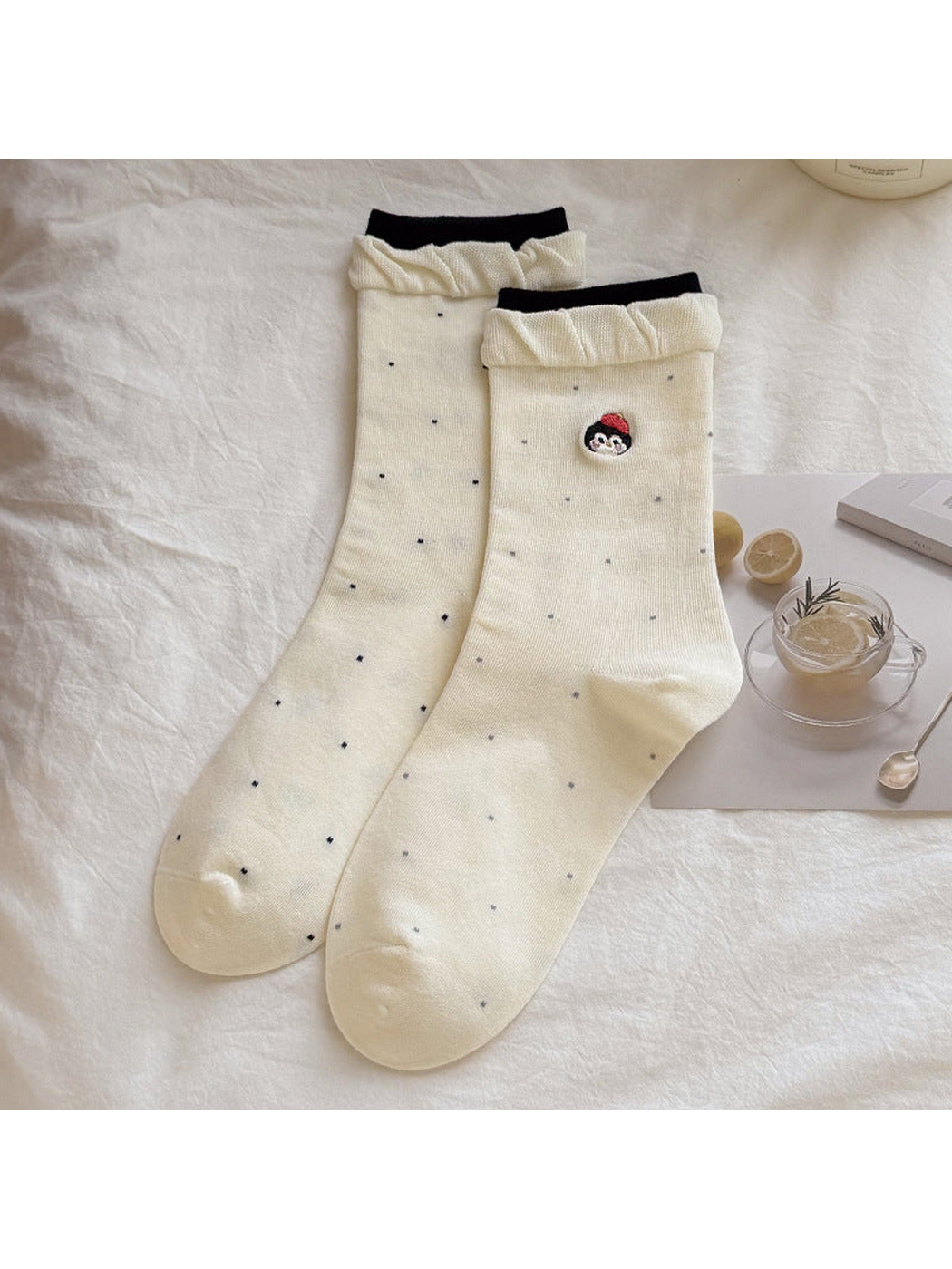 Ivory dotted crew socks with character embroidery and ruffled cuffs