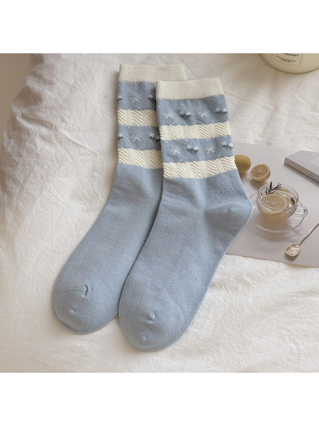 Light blue crew socks with cream textured stripes and small motifs