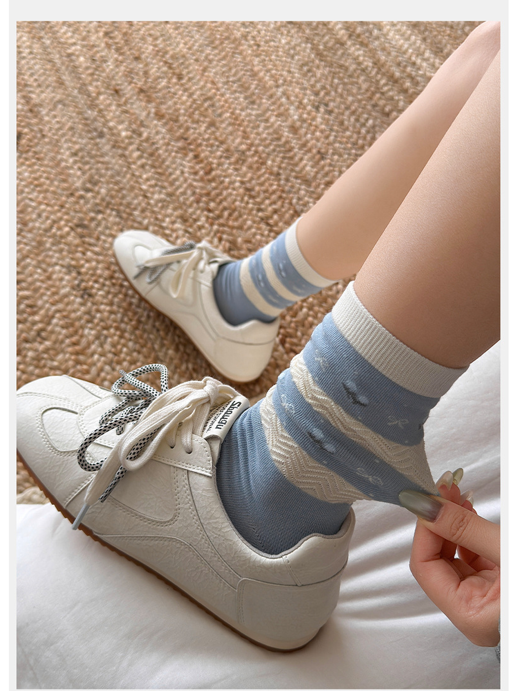 Light blue striped crew socks worn with white sneakers