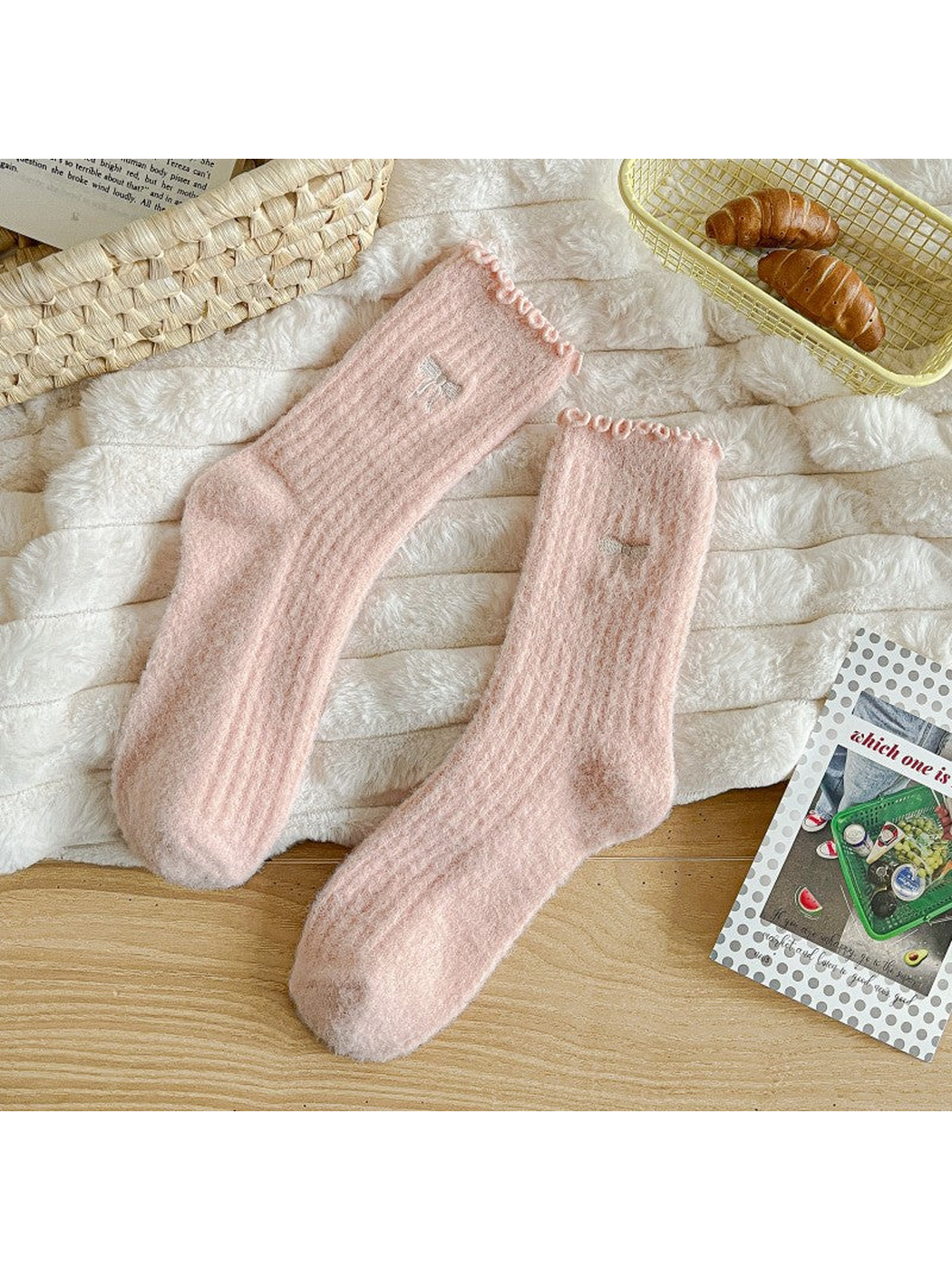 Light pink fuzzy ribbed socks with ruffled cuffs and bow motifs