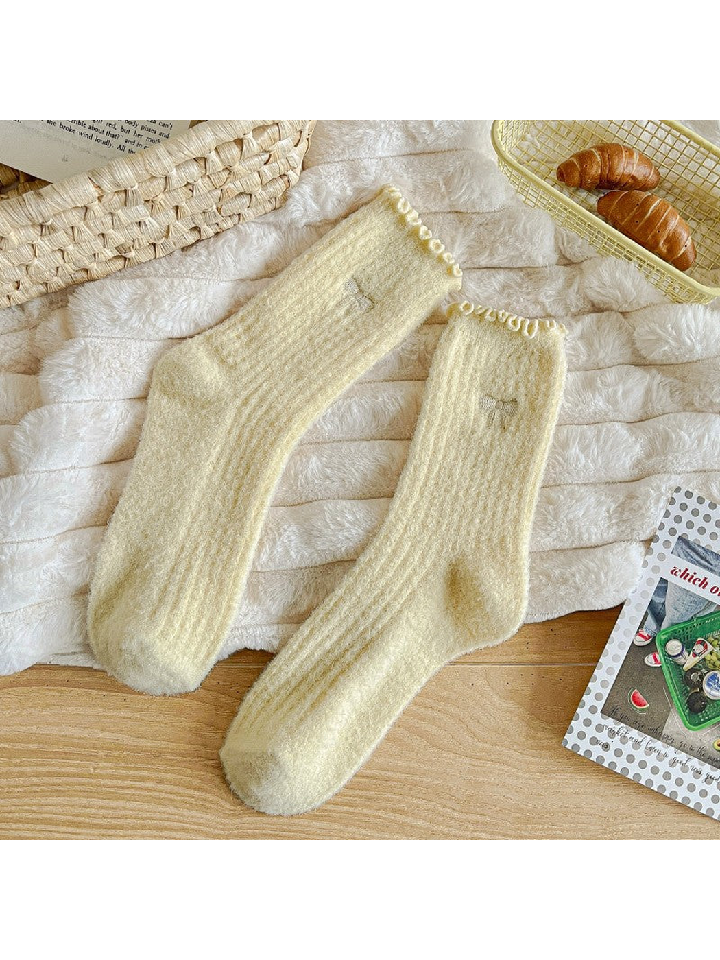 Pale yellow fuzzy ribbed socks with ruffled cuffs and bow motifs