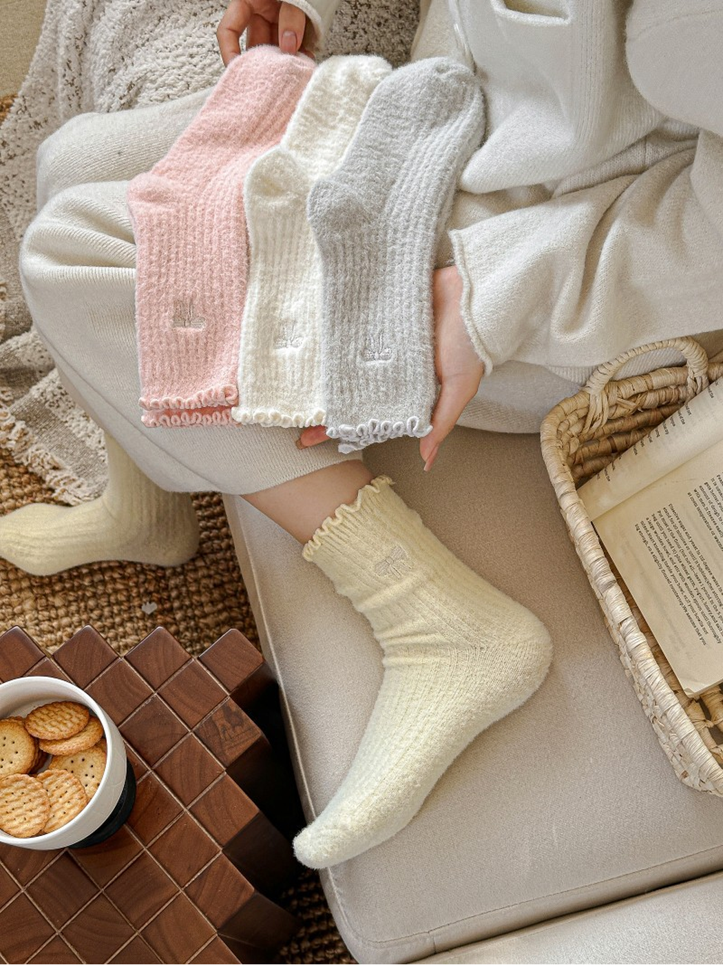 Pale yellow socks worn while pink, ivory and gray colors are held together