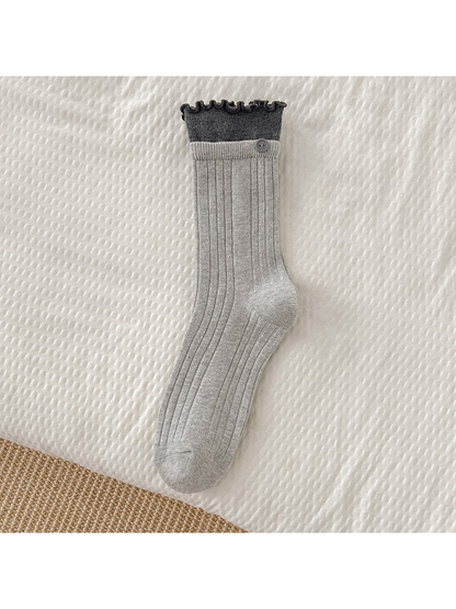 Light gray ribbed crew sock with dark gray ruffle cuff and button accent