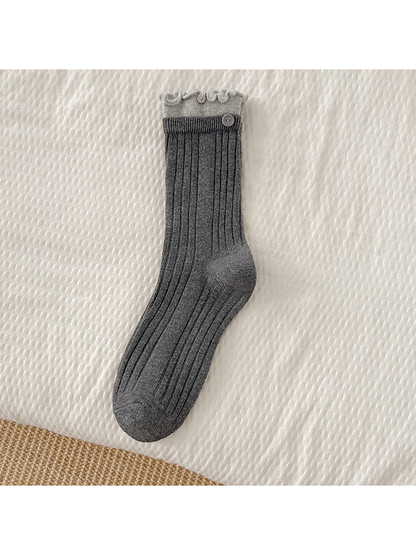 Dark gray ribbed crew sock with light gray ruffle cuff and button accent