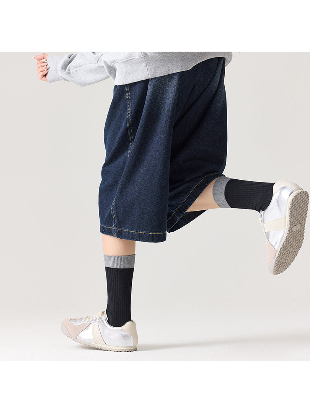 Black ribbed socks with gray cuffs styled with silver sneakers