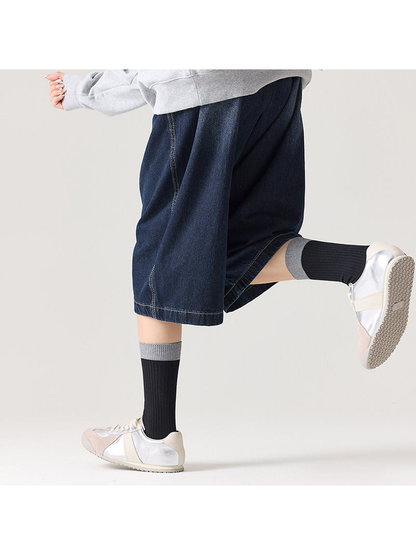 Black ribbed socks with gray cuffs styled with silver sneakers