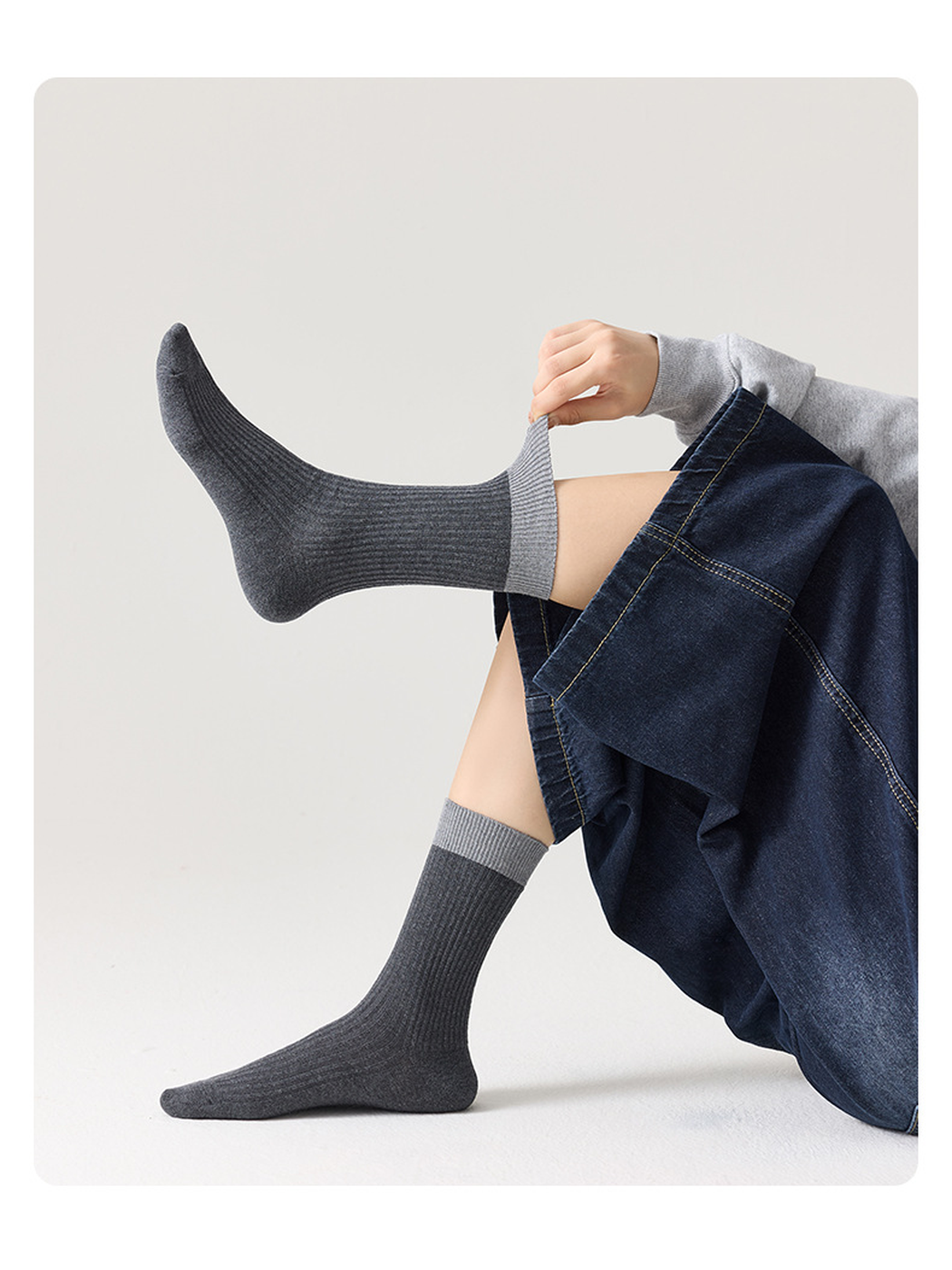 Dark gray ribbed socks with light gray cuffs shown without shoes