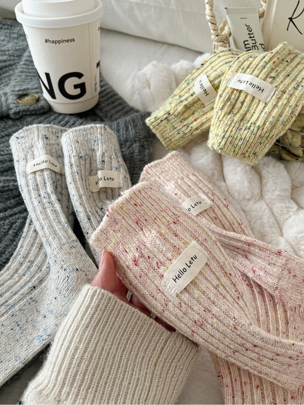 Close-up of pink, ivory and yellow flecked sock textures