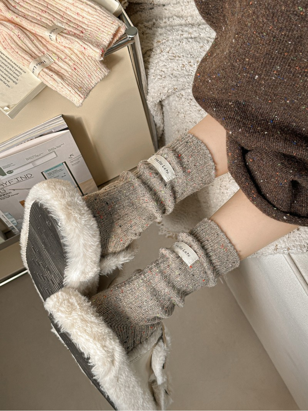 Light brown flecked crew socks worn with plush slippers