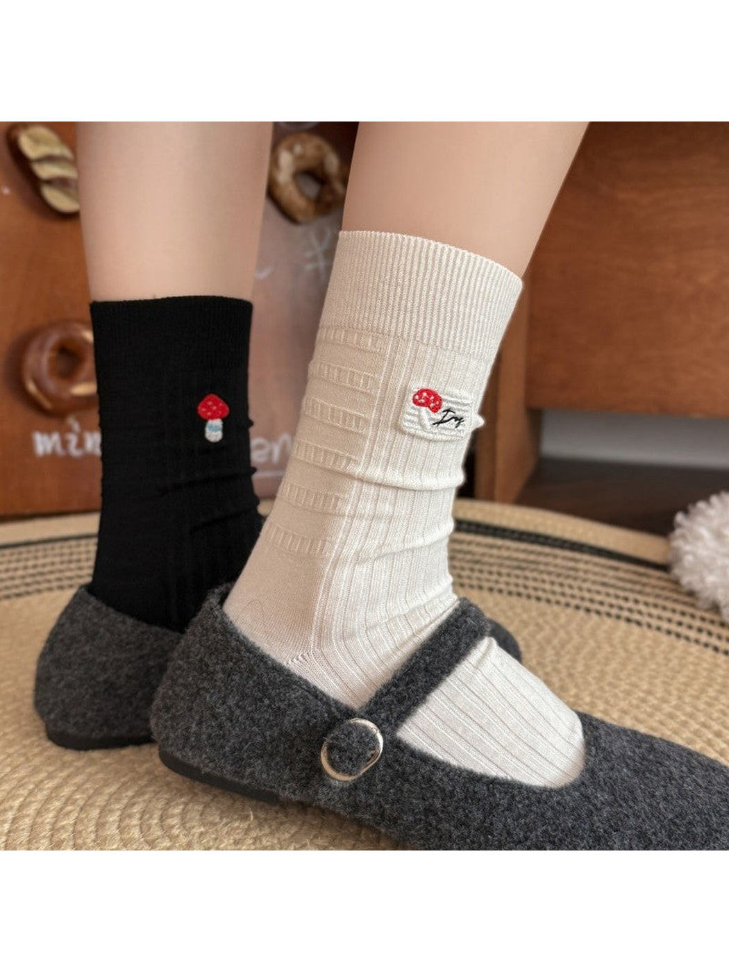 Black and ivory mushroom socks styled with gray Mary Jane shoes