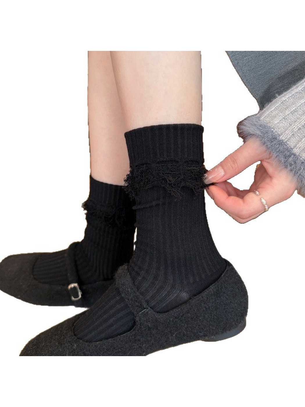 Black ribbed crew socks with fuzzy cuff trim, worn with black flats