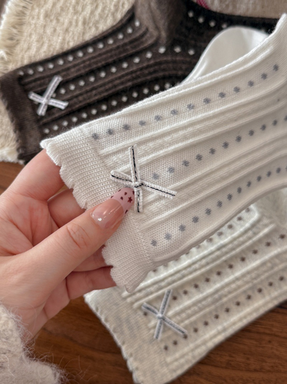 Close-up of the ribbon bow, raised ribbing and scalloped sock cuff