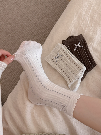 White dotted crew sock stretched at the heel beside beige and brown color options