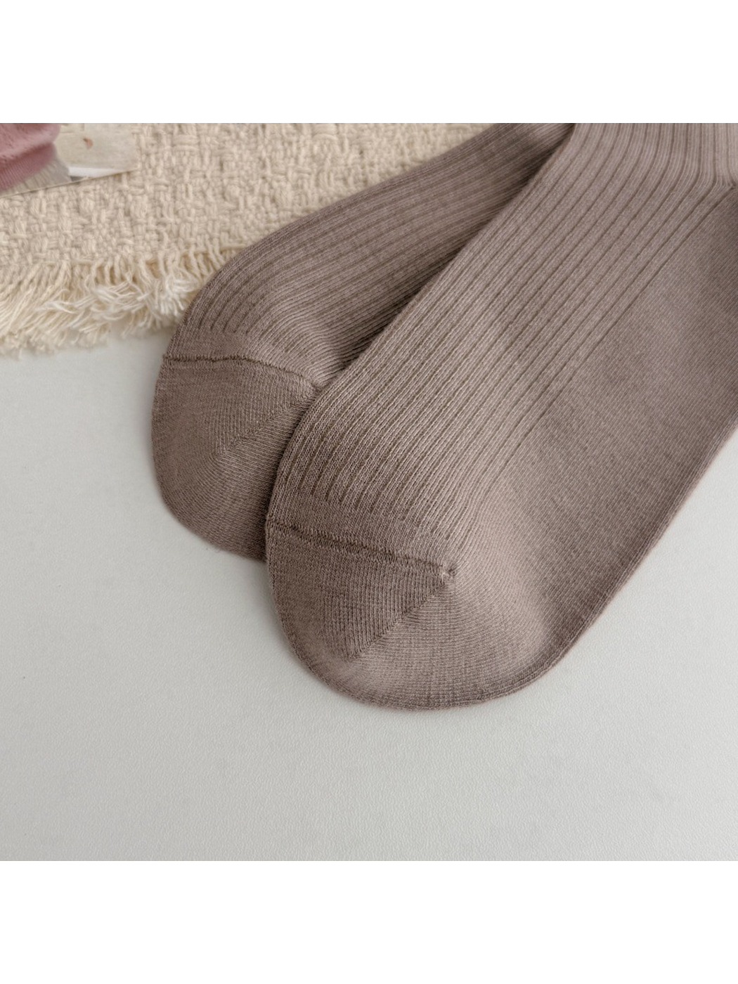 Close-up of taupe sock toes and visible toe seams