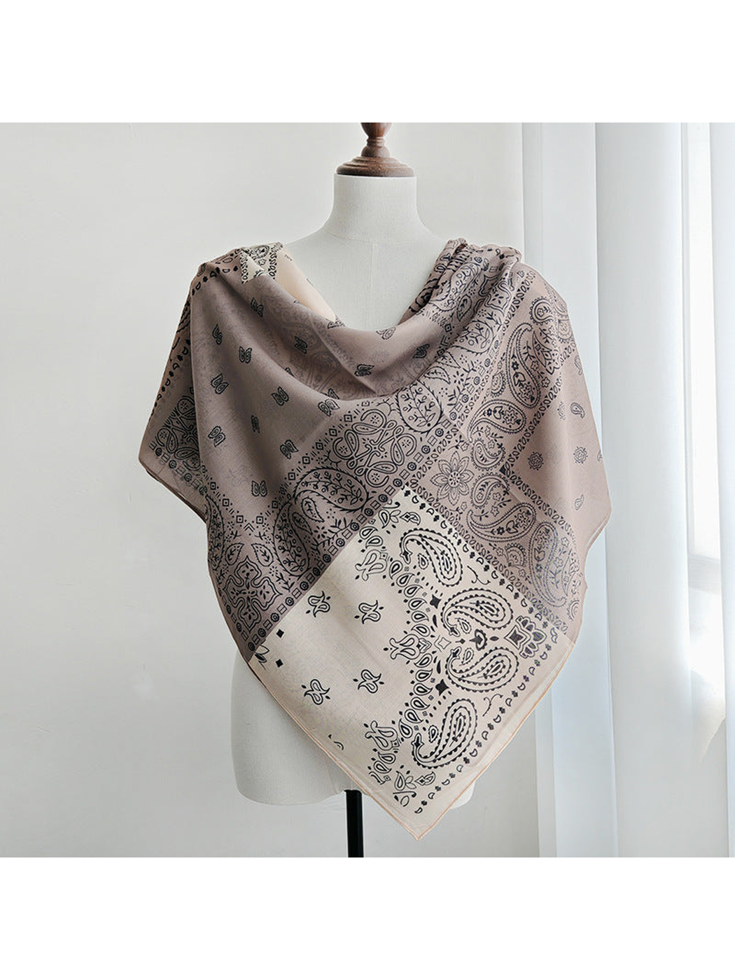 Paisley patchwork square scarf draped across the shoulders with a pointed front