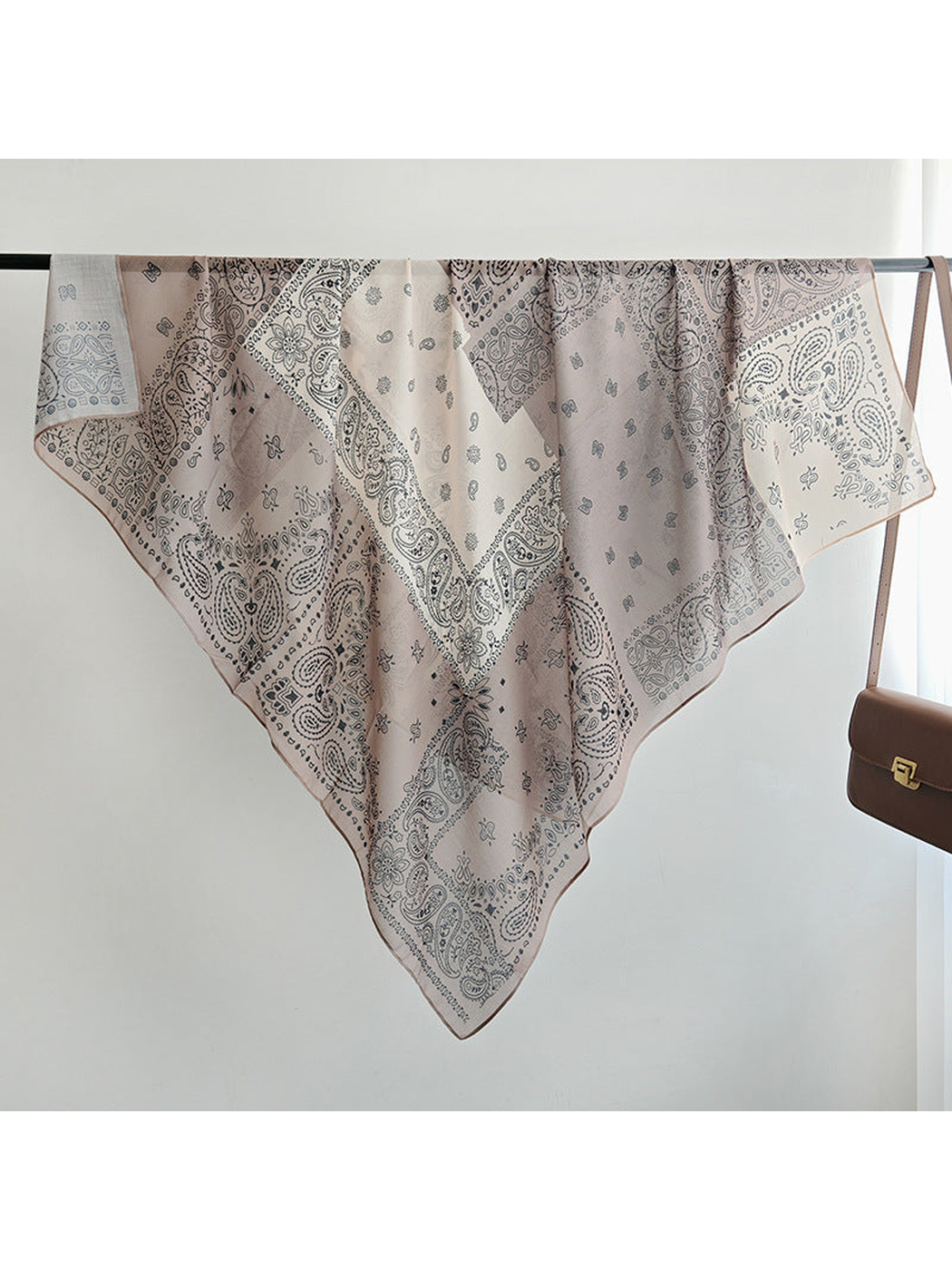 Paisley patchwork square scarf displayed diagonally over a rail