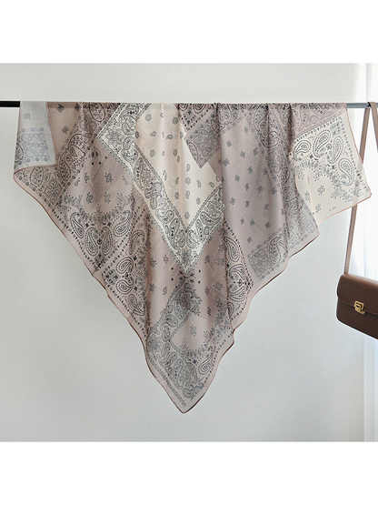 Paisley patchwork square scarf displayed diagonally over a rail