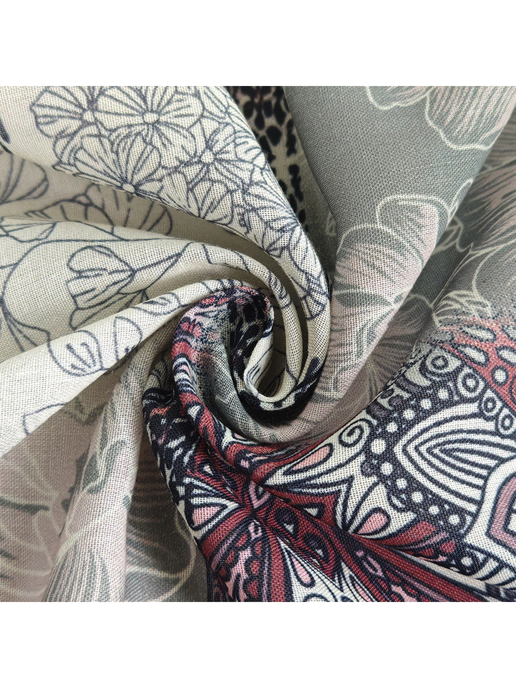 Close-up of the scarf's fine woven-look texture and printed motifs
