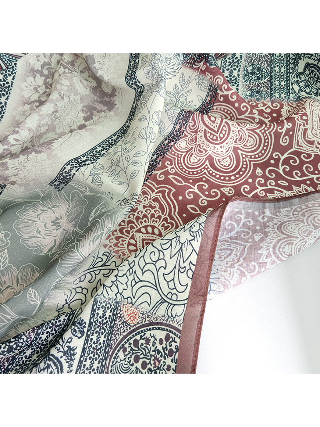Close-up of the scarf's floral, paisley and ornamental patchwork print