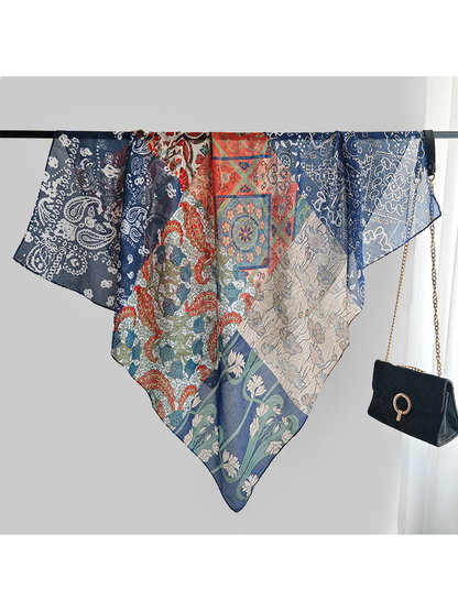 Multicolor patchwork square scarf spread over a display rail