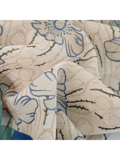 Close-up of the scarf's fine open weave and pale floral print