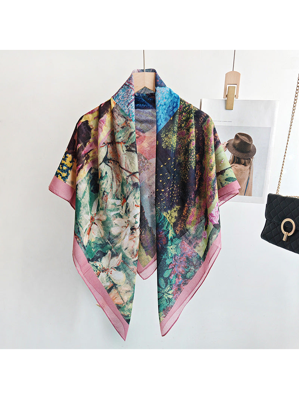 Multicolor square scarf draped over a hanger with a dusty-pink border