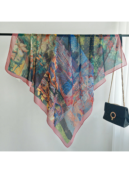 Multicolor square scarf spread across a rail to show its flowing drape