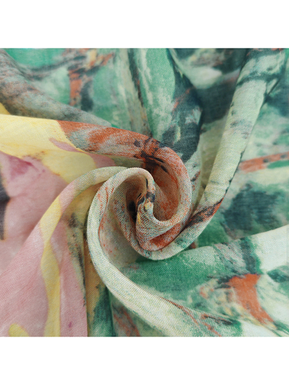 Close-up of the scarf's fine woven texture and gathered multicolor print