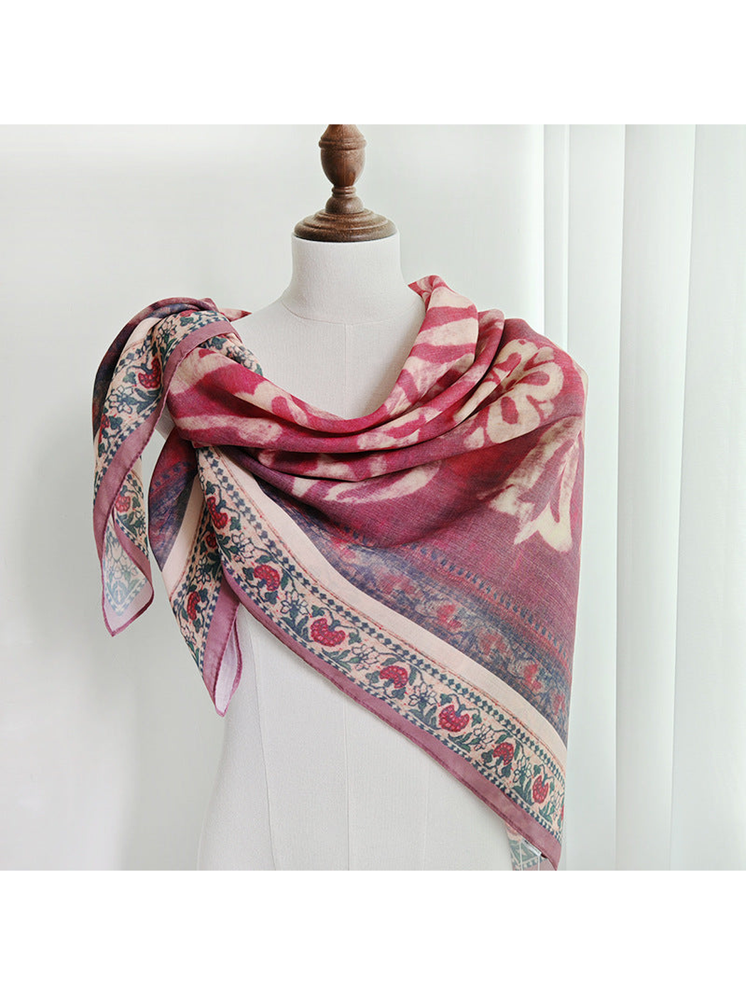 Rose and mauve patterned scarf draped around the shoulders