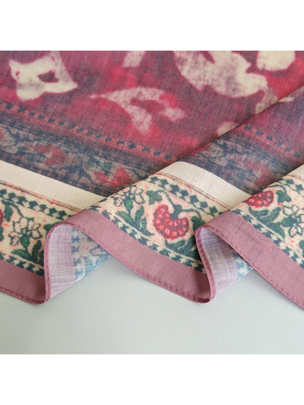 Close-up of the floral border and narrow mauve stitched edge