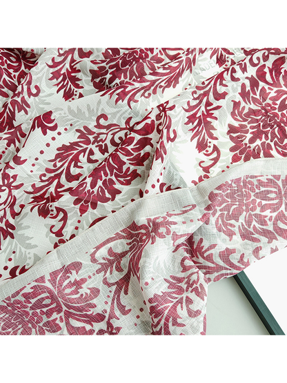 Close-up of the red floral pattern, pale border and flowing folds