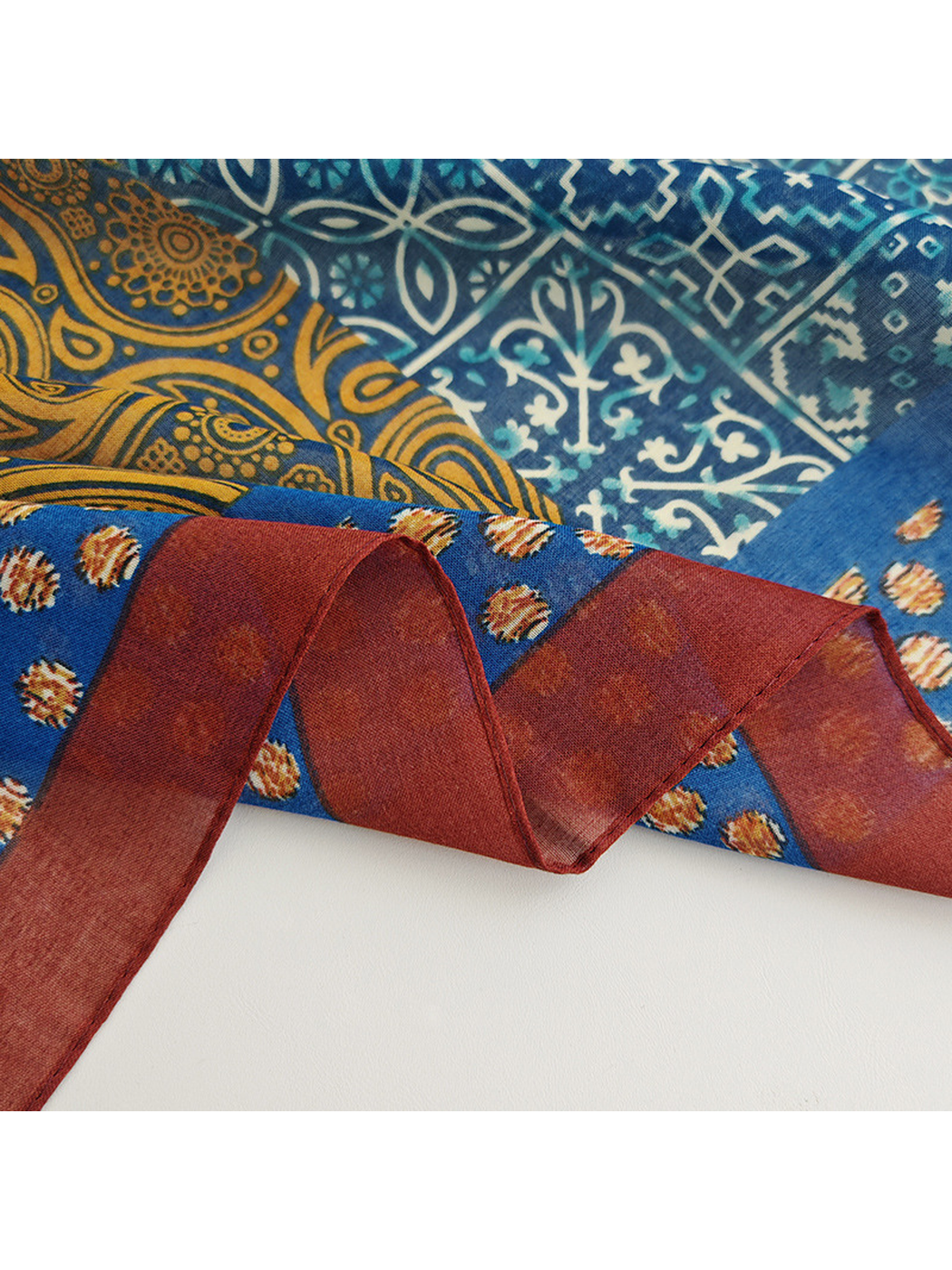 Close-up of the narrow burgundy border and stitched scarf edge