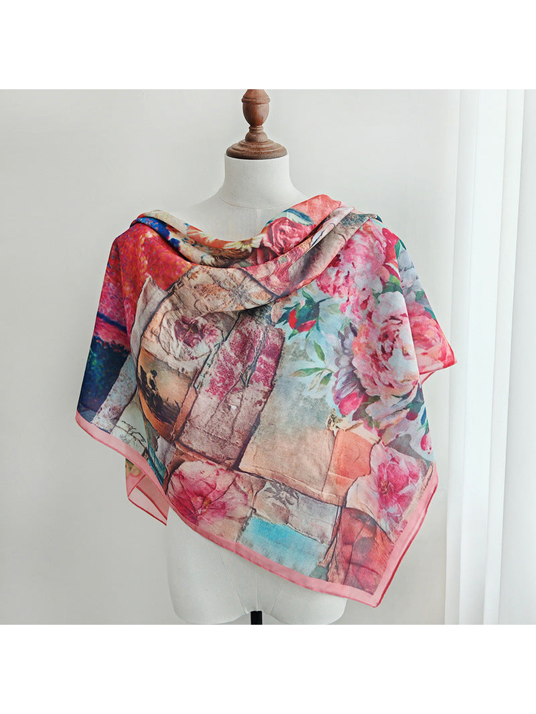 Multicolor floral scarf draped broadly across a mannequin's shoulders